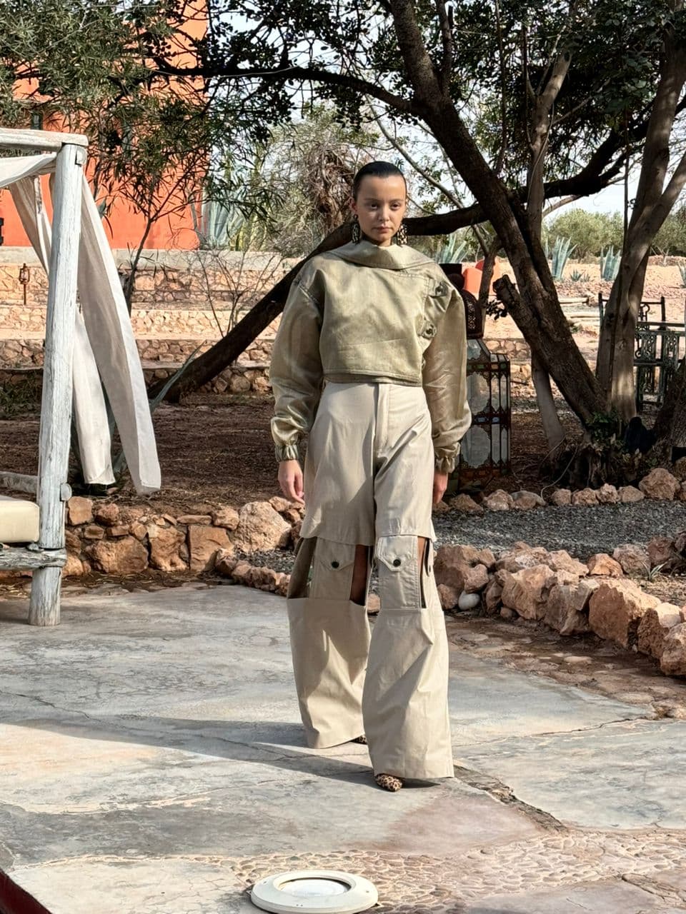 Model wearing a bespoke cream bustier crop jacket and wide-leg trousers.